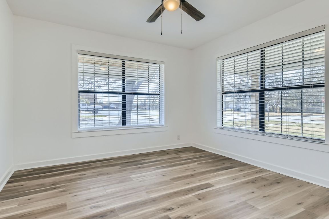 902 Hackberry Street Taylor, TX 76574 - Photo 14 of 29 Empty room featuring light wood-style flooring and a ceiling fan