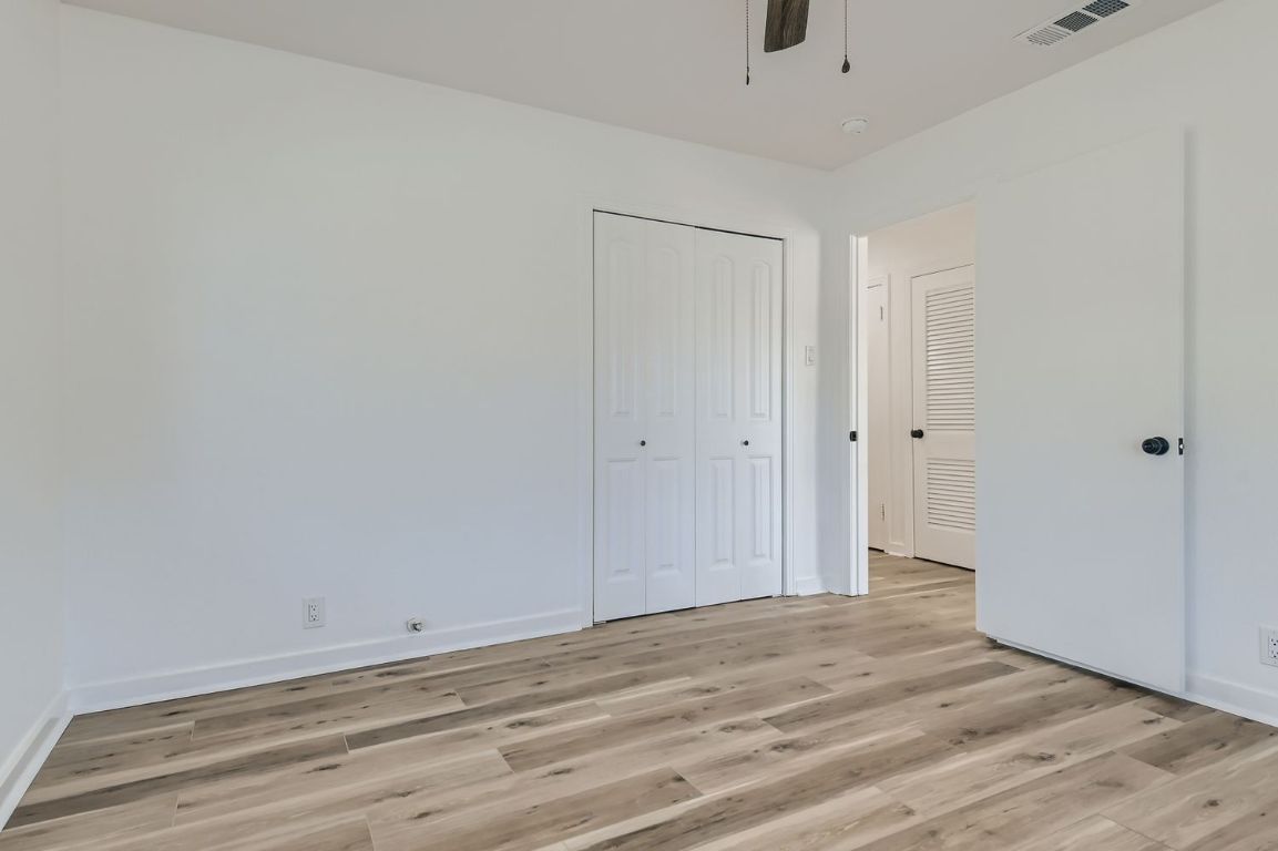 902 Hackberry Street Taylor, TX 76574 - Photo 15 of 29 Unfurnished bedroom with light wood-style floors, a closet, and ceiling fan