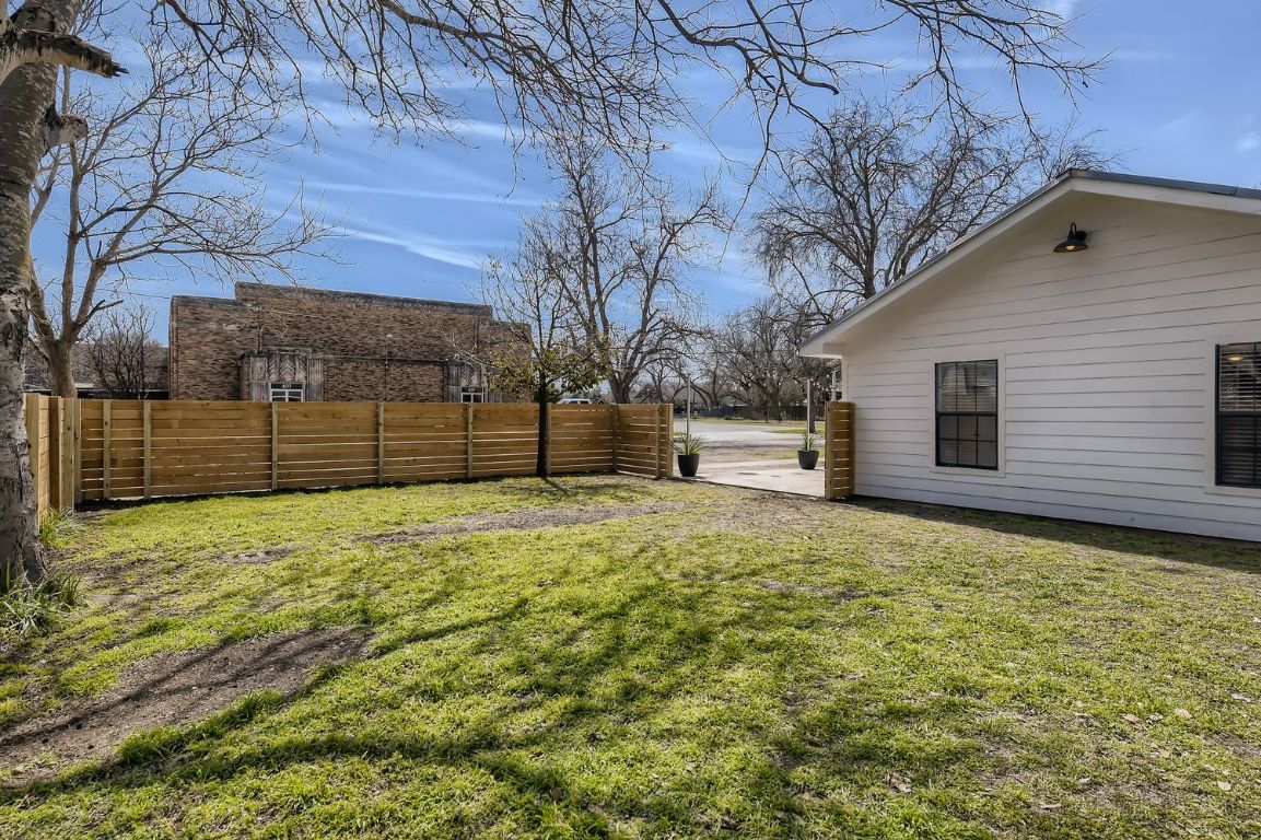 902 Hackberry Street Taylor, TX 76574 - Photo 16 of 18 a backyard of a house with a large tree