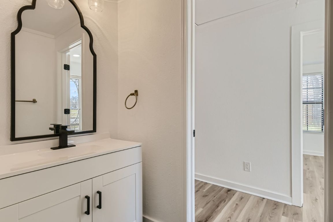 902 Hackberry Street Taylor, TX 76574 - Photo 19 of 29 Bathroom featuring vanity and light wood-style floors