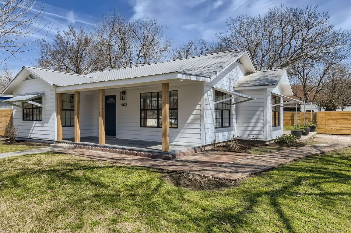 902 Hackberry Street Taylor, TX 76574 - Photo 28 of 29 View of front of house featuring a porch and a metal roof