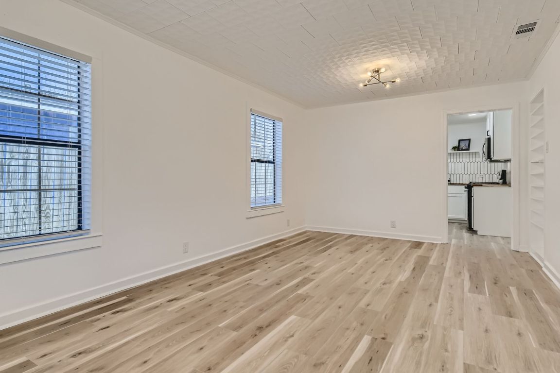 902 Hackberry Street Taylor, TX 76574 - Photo 4 of 29 Spare room with baseboards and light wood-style flooring