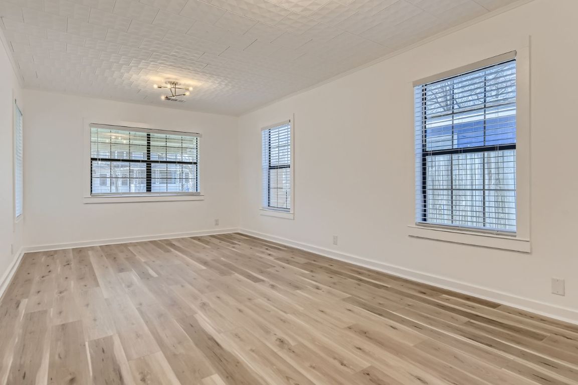 902 Hackberry Street Taylor, TX 76574 - Photo 5 of 29 Unfurnished room with baseboards and light wood-style floors