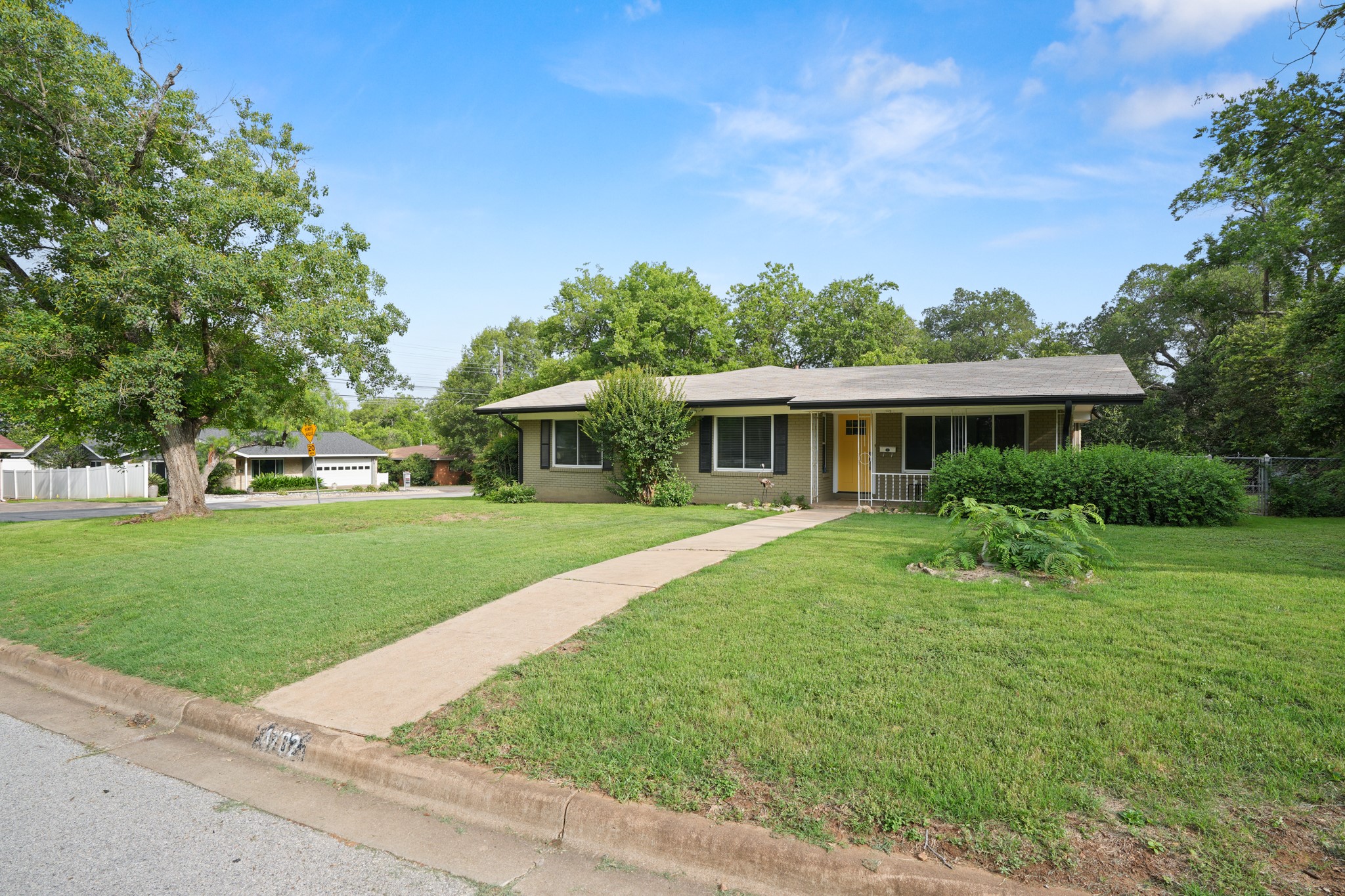 4702 Lasso Path Austin, TX 78745 - Photo 31 of 38 A classic ranch-style home awaits with ample front yard space and mature landscaping.
