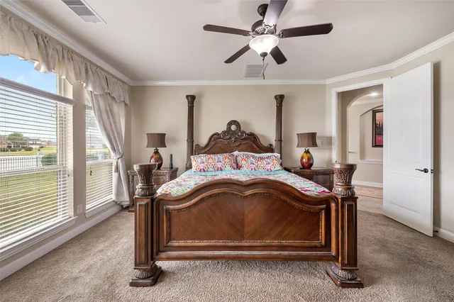 a bed sitting in a room next to a window