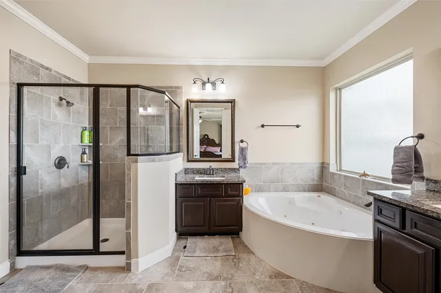 a spacious bathroom with a tub sink shower and mirror