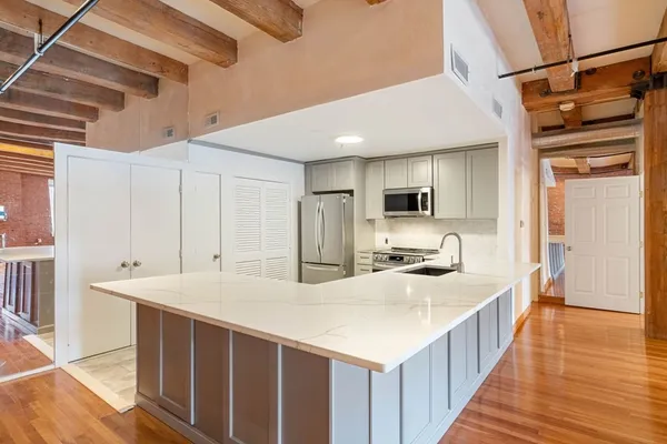 a kitchen with stainless steel appliances a sink and a refrigerator