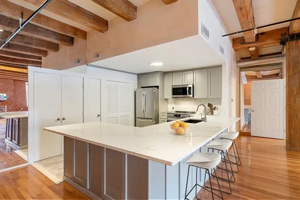 a kitchen with a sink a stove and chairs