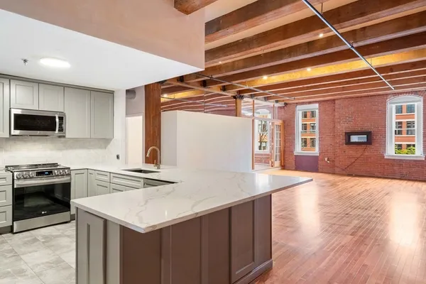 a kitchen with a stove a sink and a refrigerator