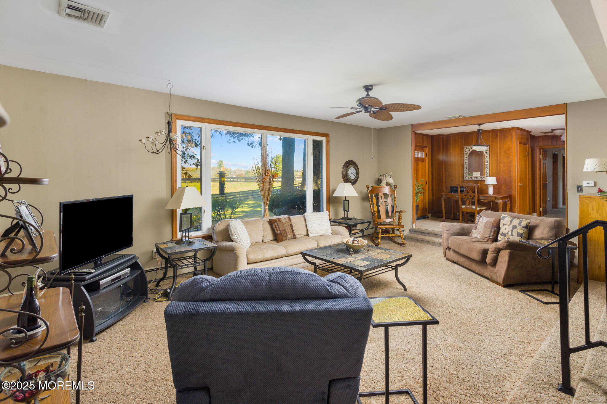 193 Burlington Path Road Cream Ridge, NJ 08514 - Photo 11 of 51 a living room with furniture a ceiling fan and a flat screen tv