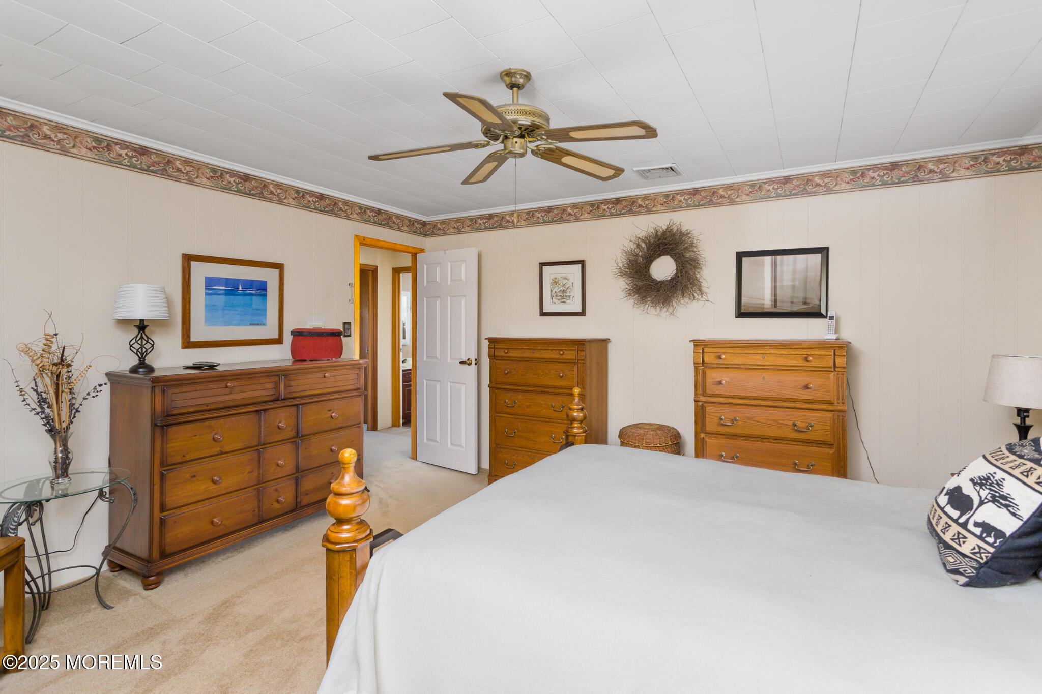 193 Burlington Path Road Cream Ridge, NJ 08514 - Photo 22 of 51 a bedroom with a bed and a chandelier