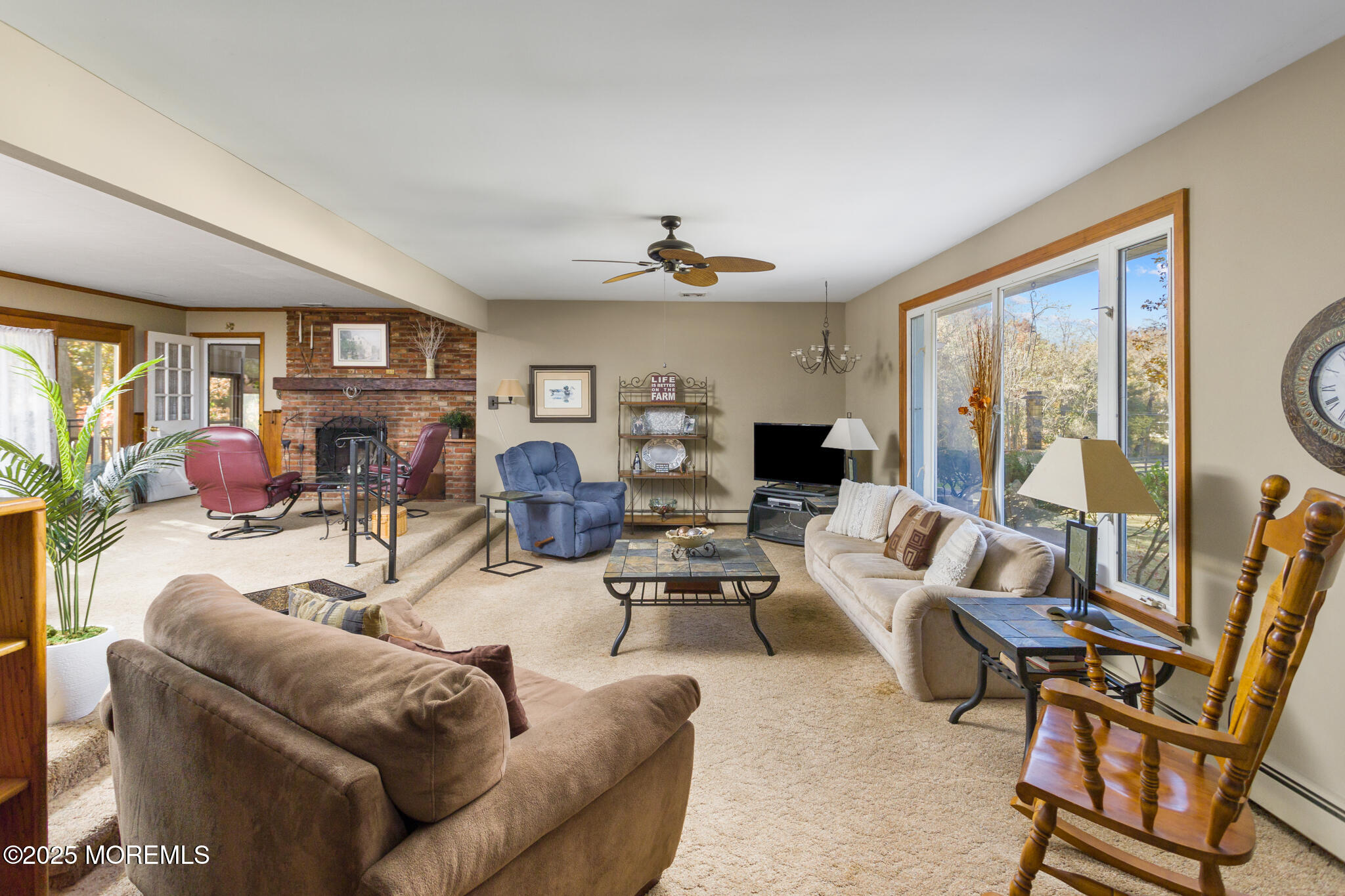 193 Burlington Path Road Cream Ridge, NJ 08514 - Photo 10 of 51 a living room with furniture a fireplace and a large window