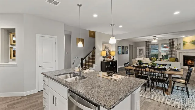 a kitchen with stainless steel appliances granite countertop a sink refrigerator and cabinets