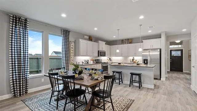 a kitchen with granite countertop a sink counter top space appliances and cabinets
