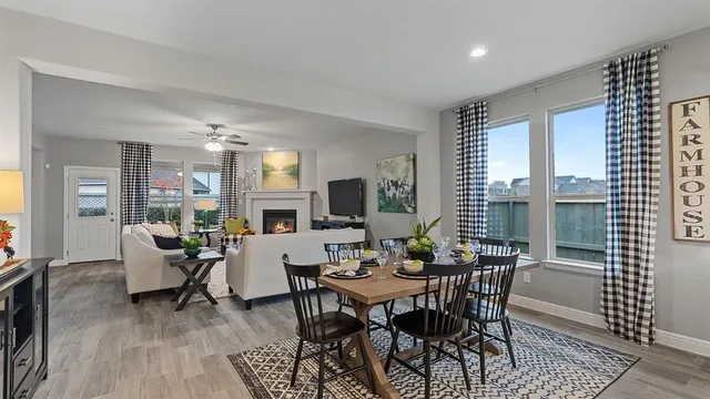 a kitchen with a stove a kitchen island a table and chairs