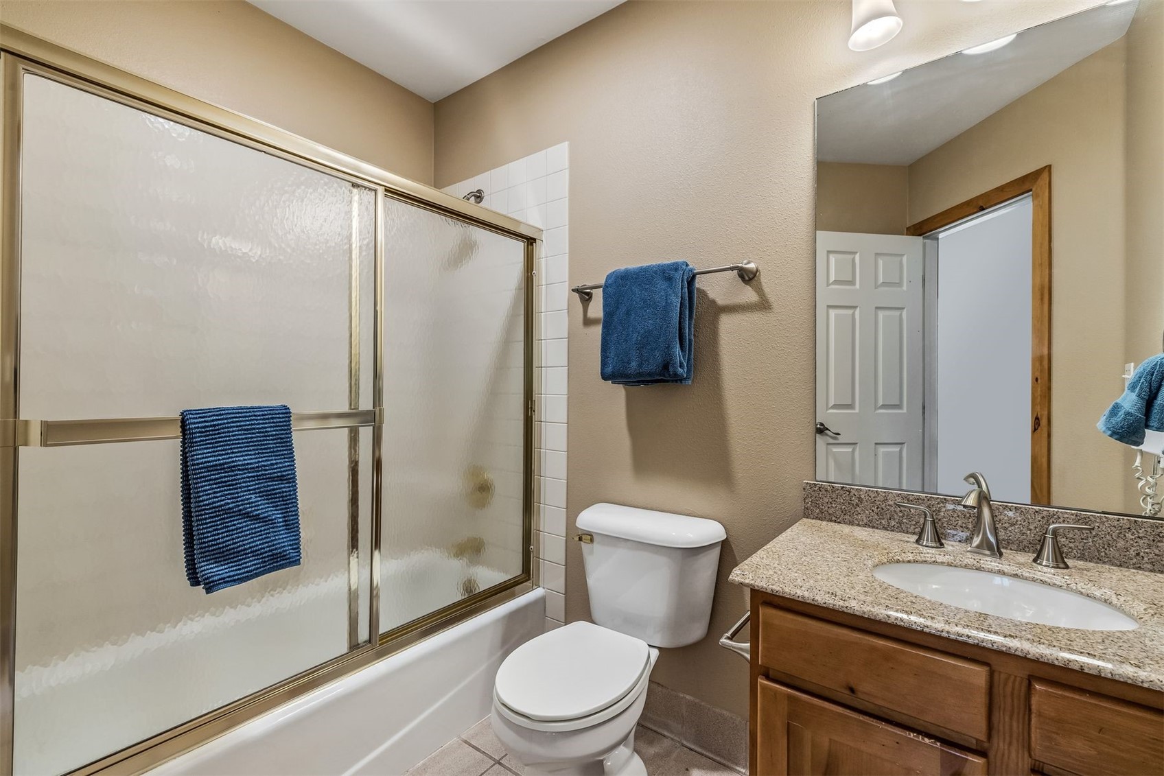 71 Starfire Lane, Unit 1978 Keystone, CO 80435 - Photo 23 of 40 a bathroom with a granite countertop sink toilet and shower