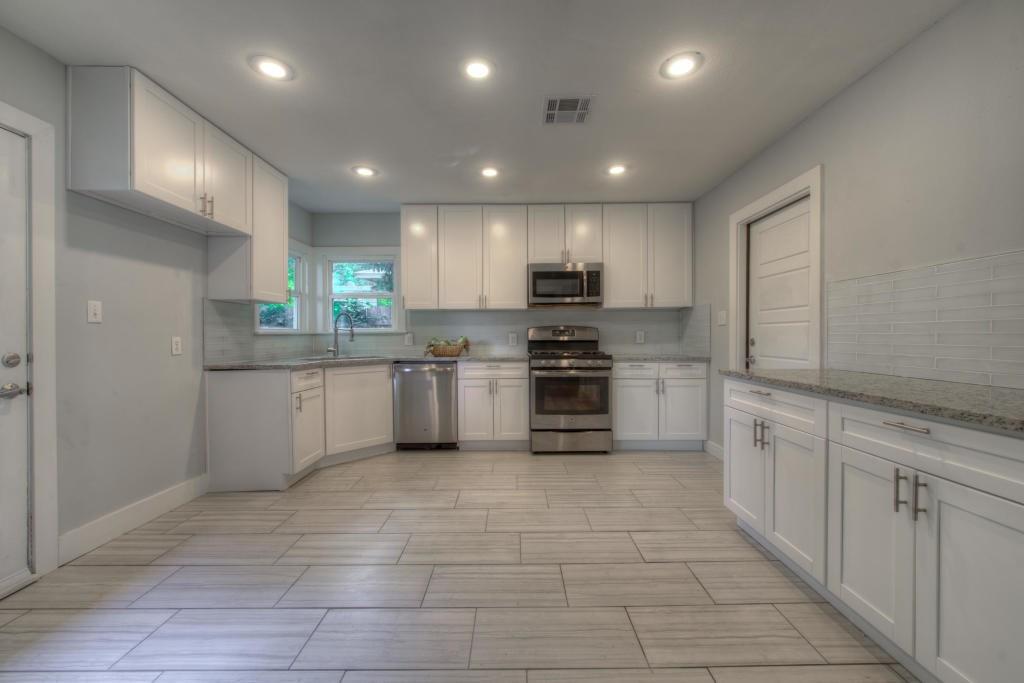 2011 Fort View Road Austin, TX 78704 - Photo 12 of 28 Gleaming stone countertops and modern stainless steel appliances anchor this bright kitchen space.