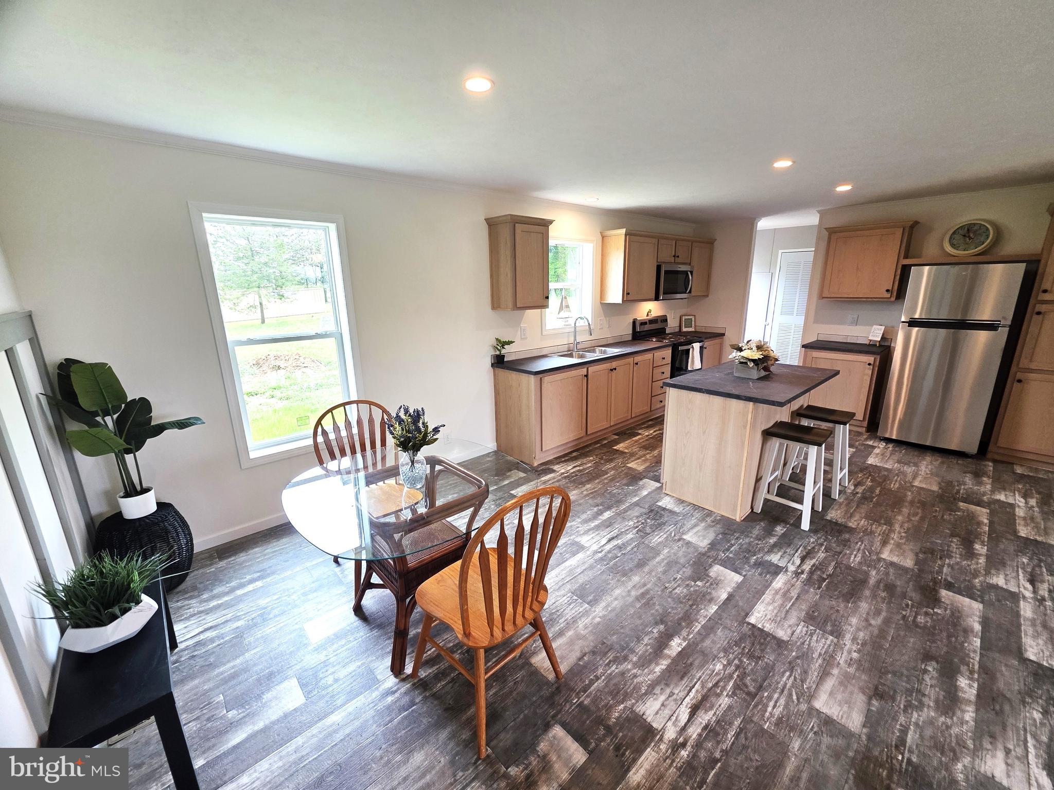 289 Grove Neck Road Earleville, MD 21919 - Photo 3 of 19 a view of a dining room with furniture a potted plant and wooden floor