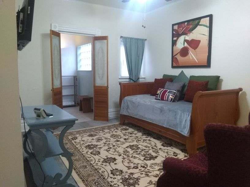 4618 Plummer Street Pittsburgh, PA 15201 - Photo 4 of 8 a living room with furniture and a rug