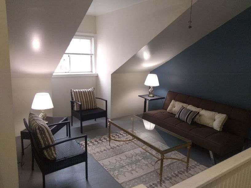 4618 Plummer Street Pittsburgh, PA 15201 - Photo 6 of 8 a living room with furniture a lamp and a window