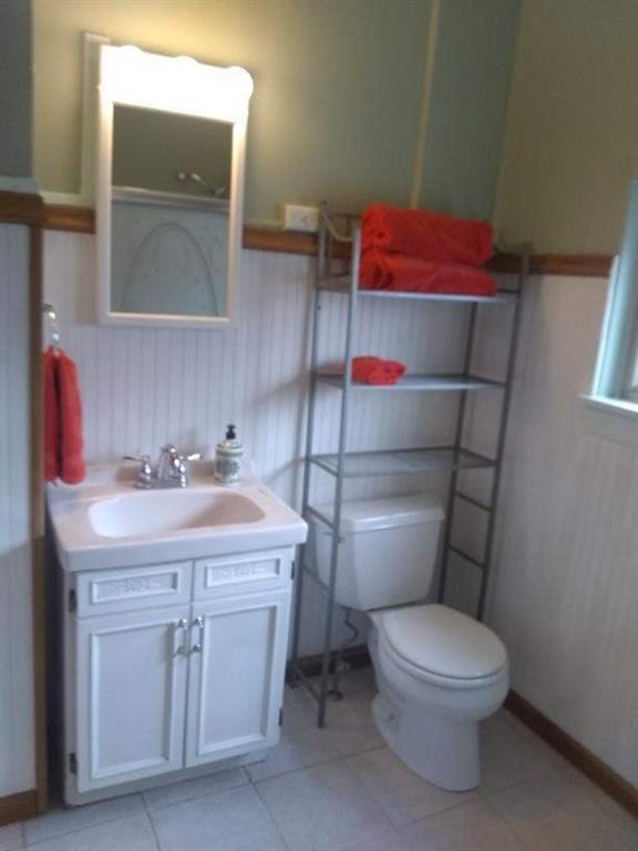 4618 Plummer Street Pittsburgh, PA 15201 - Photo 8 of 8 a bathroom with a sink a toilet and mirror