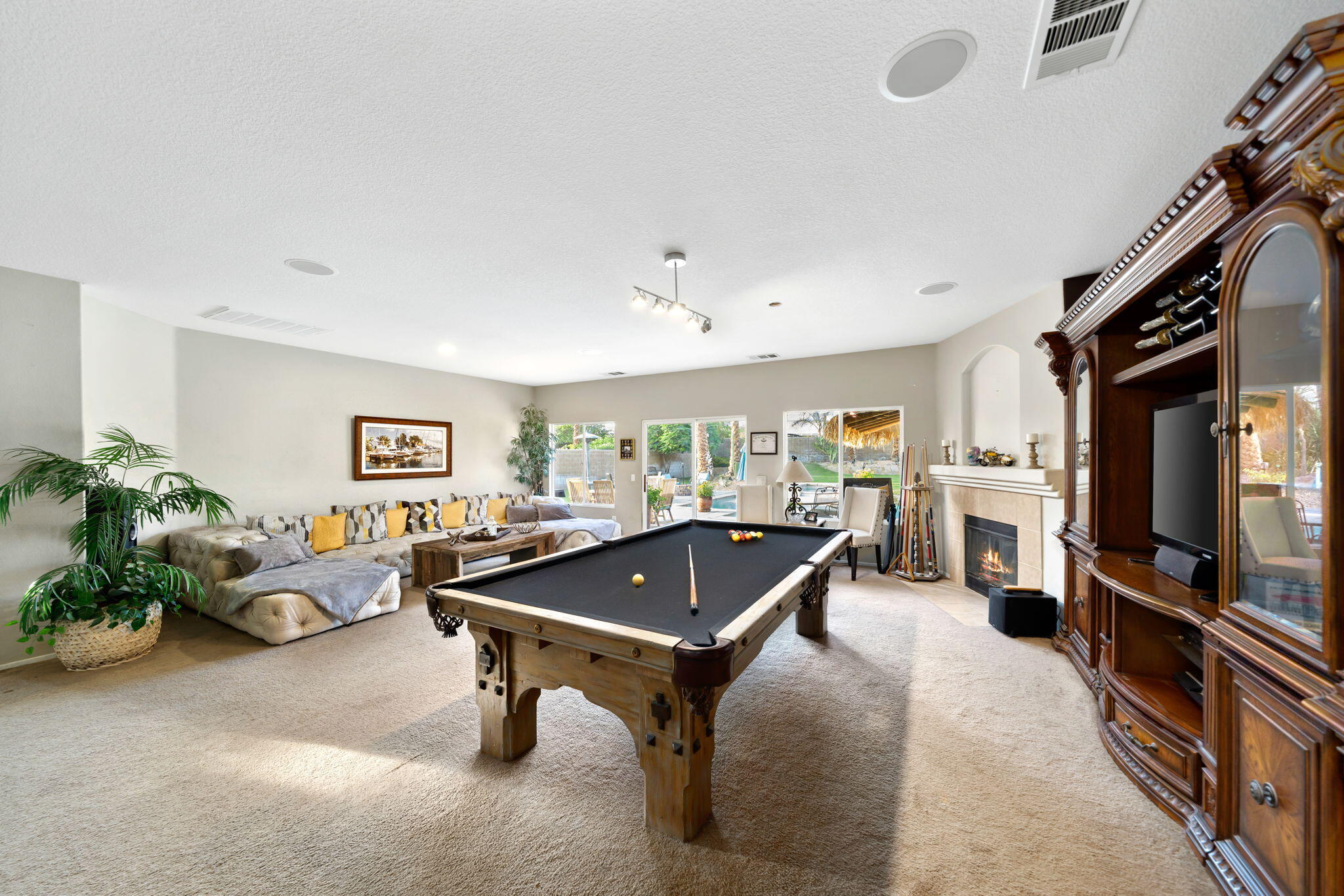 83258 Brighton Crest Drive Indio, CA 92203 - Photo 16 of 69 a living room with furniture pool table and a window
