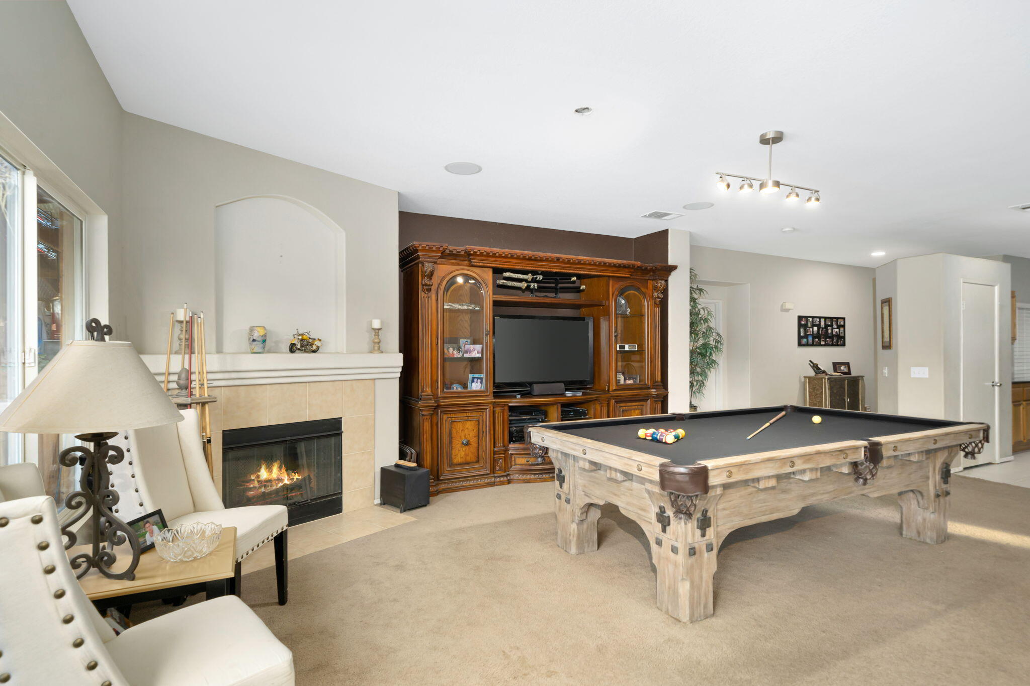 83258 Brighton Crest Drive Indio, CA 92203 - Photo 19 of 69 a living room with furniture pool table and a fireplace