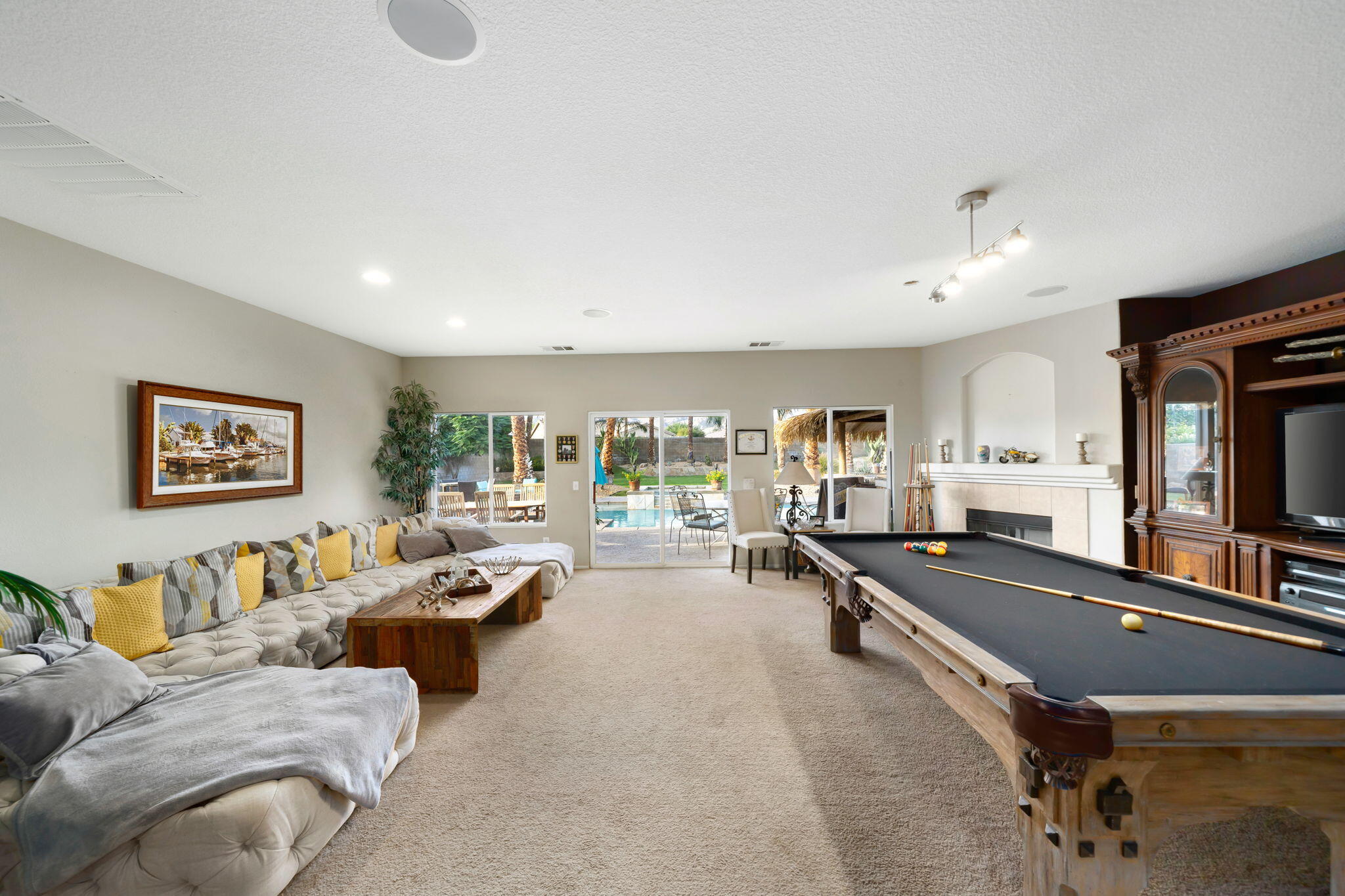 83258 Brighton Crest Drive Indio, CA 92203 - Photo 21 of 69 a living room with furniture large window and flat screen tv