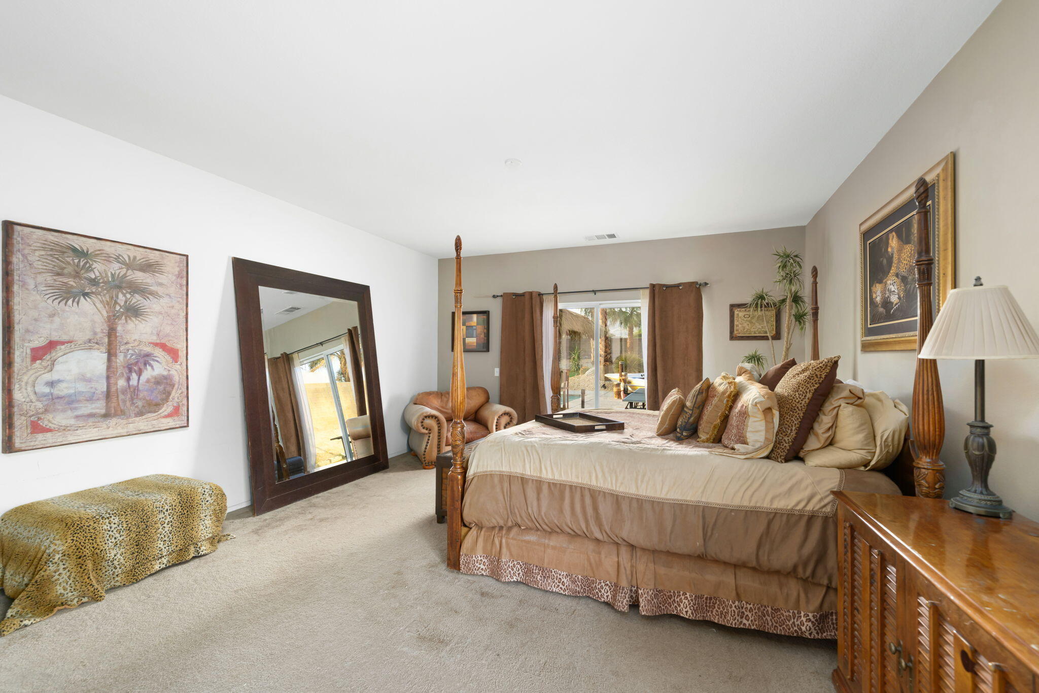 83258 Brighton Crest Drive Indio, CA 92203 - Photo 49 of 69 a bedroom with a large bed and a couch