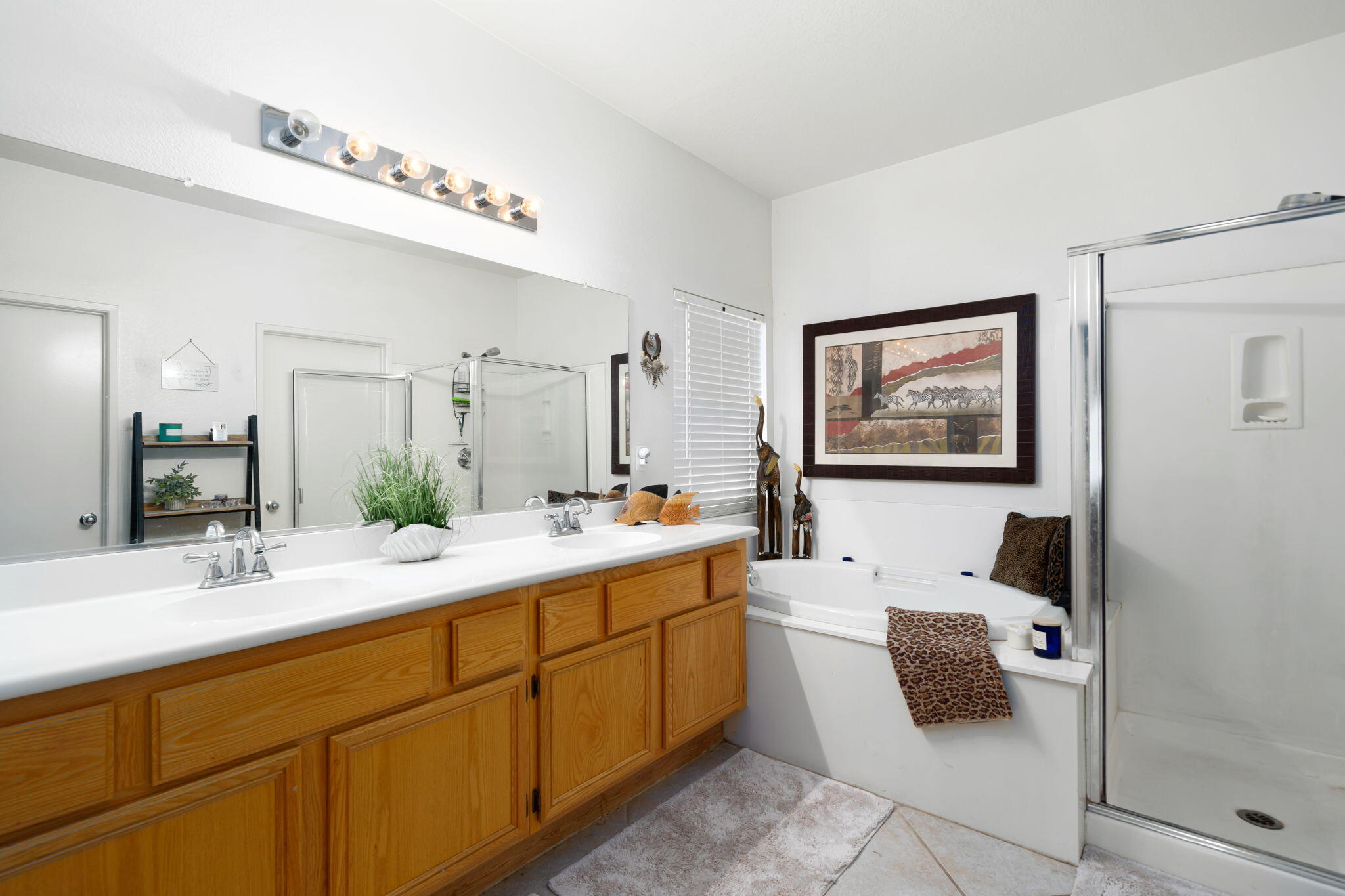 83258 Brighton Crest Drive Indio, CA 92203 - Photo 50 of 69 a en suite bathroom with a double vanity sink a mirror and a shower