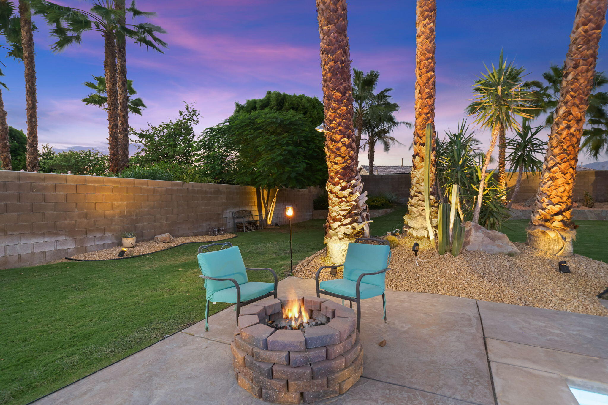 83258 Brighton Crest Drive Indio, CA 92203 - Photo 64 of 69 a view of a patio with table and chairs potted plants and palm tree