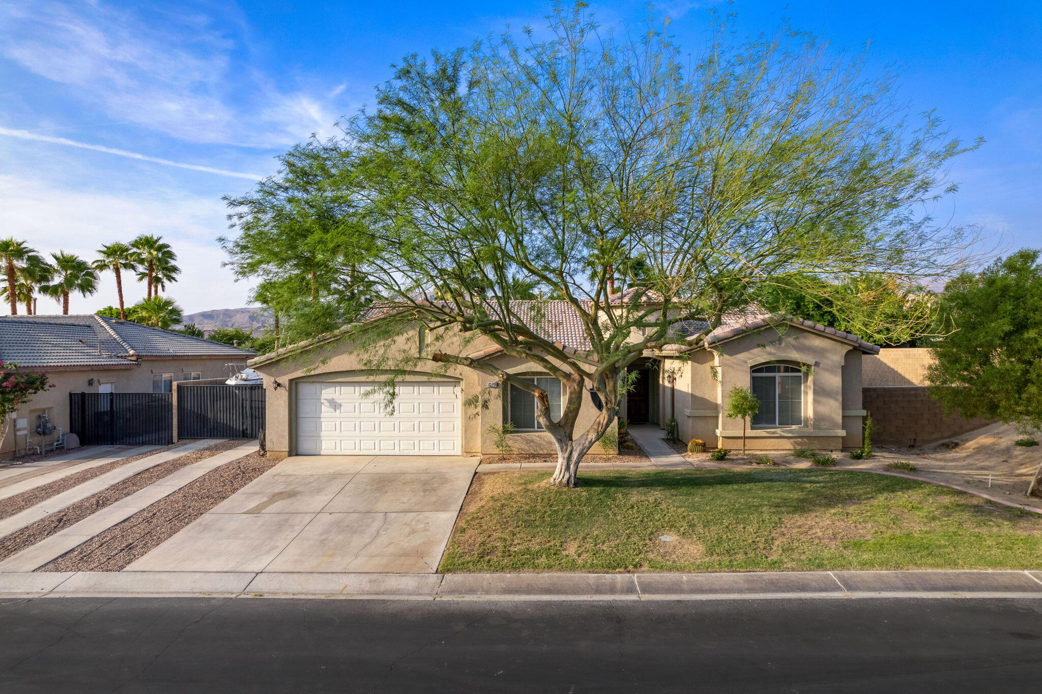 83258 Brighton Crest Drive Indio, CA 92203 - Photo 8 of 69 a front view of a house with garden