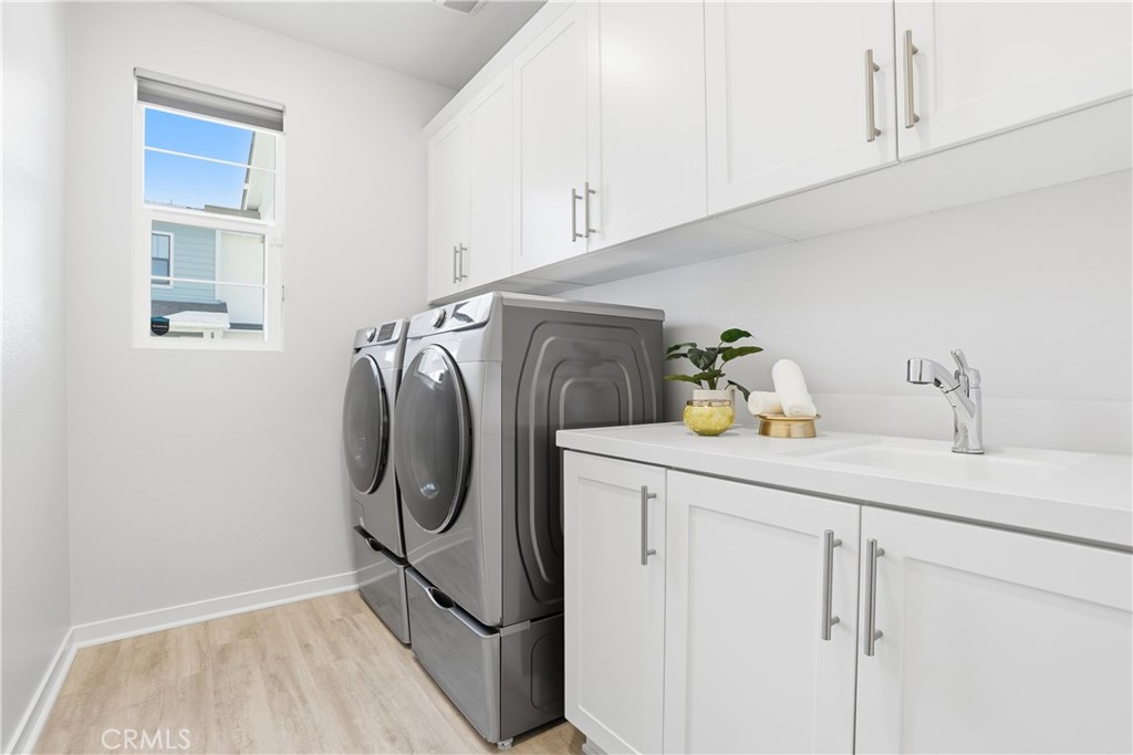 22 Jarano Street Rancho Mission Viejo, CA 92694 - Photo 39 of 75 a utility room with cabinets washer and dryer