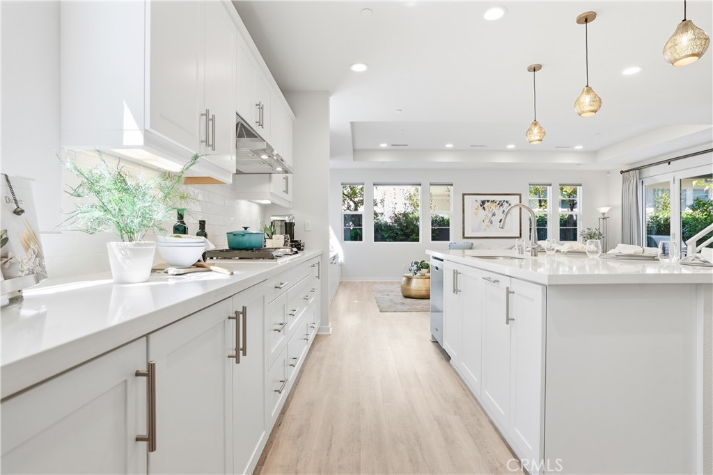 22 Jarano Street Rancho Mission Viejo, CA 92694 - Photo 8 of 75 a large white kitchen with a large window a sink and stainless steel appliances