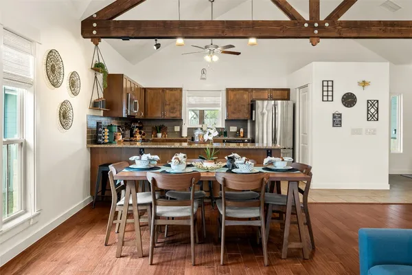 a dining room with furniture and wooden floor
