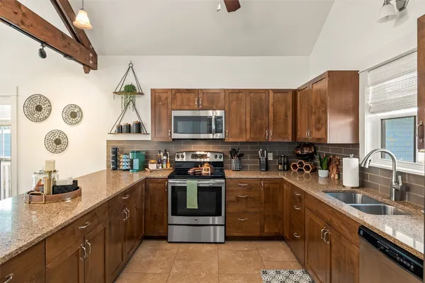 a kitchen with a sink stove and cabinets