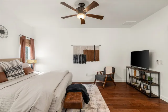 a bedroom with furniture and a flat screen tv