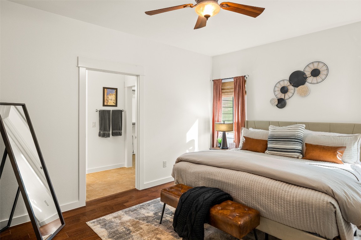 435 Hays Street Dripping Springs, TX 78620 - Photo 16 of 36 a bedroom with a bed and wooden floor