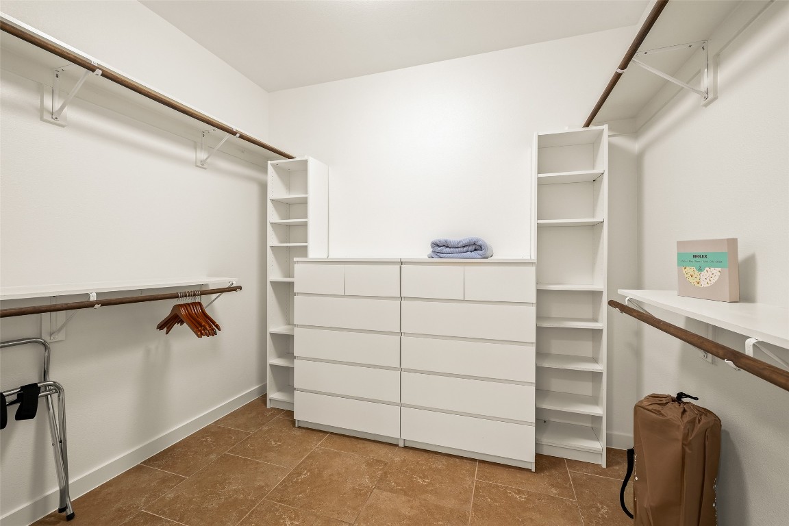 435 Hays Street Dripping Springs, TX 78620 - Photo 19 of 36 a view of walk in closet with clothes and shoes