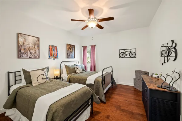 a bedroom with two beds and a desk