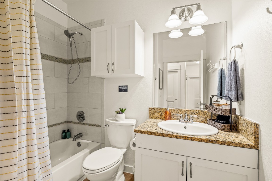 435 Hays Street Dripping Springs, TX 78620 - Photo 22 of 36 a bathroom with a sink a toilet and shower
