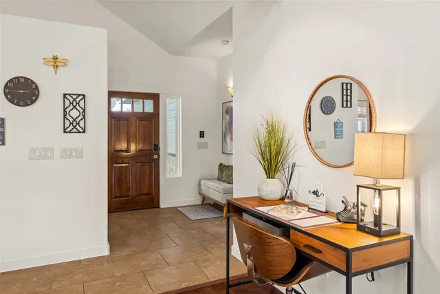 a living room with furniture a table and wooden floor