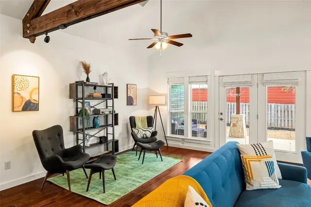 a living room with furniture and a floor to ceiling window