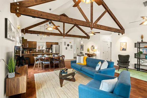 a living room with furniture and wooden floor