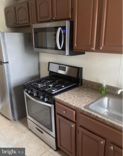 3614 2nd Street Baltimore, MD 21225 - Photo 4 of 4 a kitchen with granite countertop a stove and a sink
