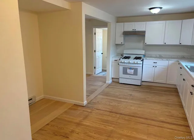 a kitchen with a stove a sink and a refrigerator