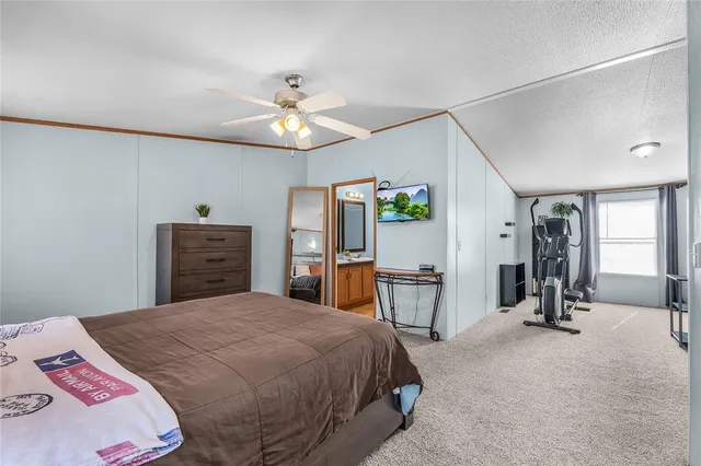 a bedroom with a bed a dresser and chair