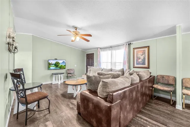 a living room with furniture a bed and a window