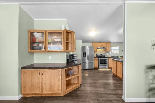 a kitchen with granite countertop a stove and cabinets