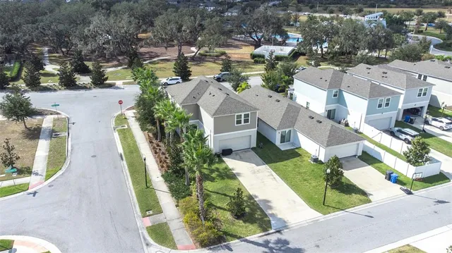 an aerial view of residential houses with outdoor space